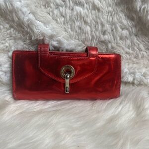 Kate Spade patent leather Red bifold wallet with silver tone hardwares .